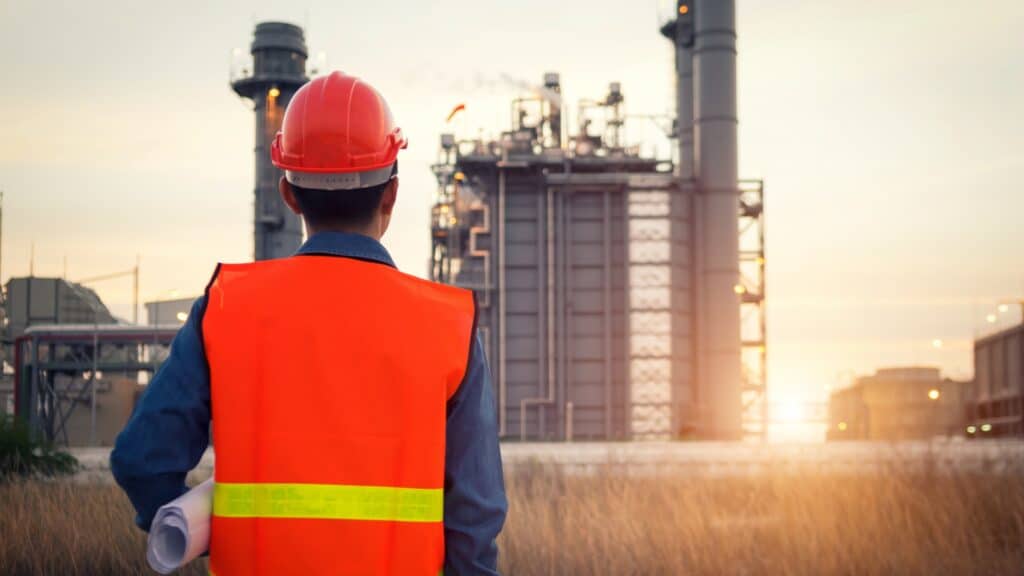 Construction worker looking over site.